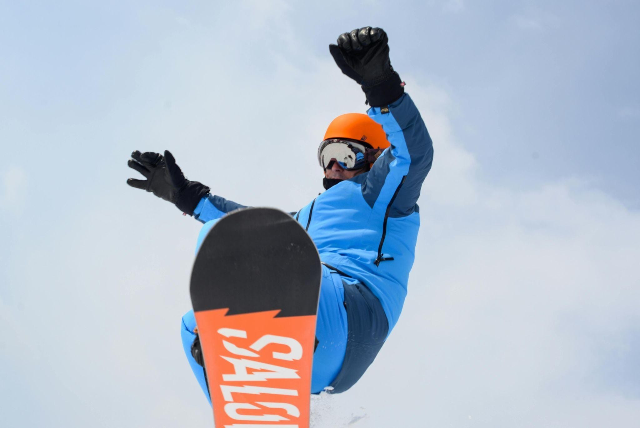 Upward view of a man on a snowboard