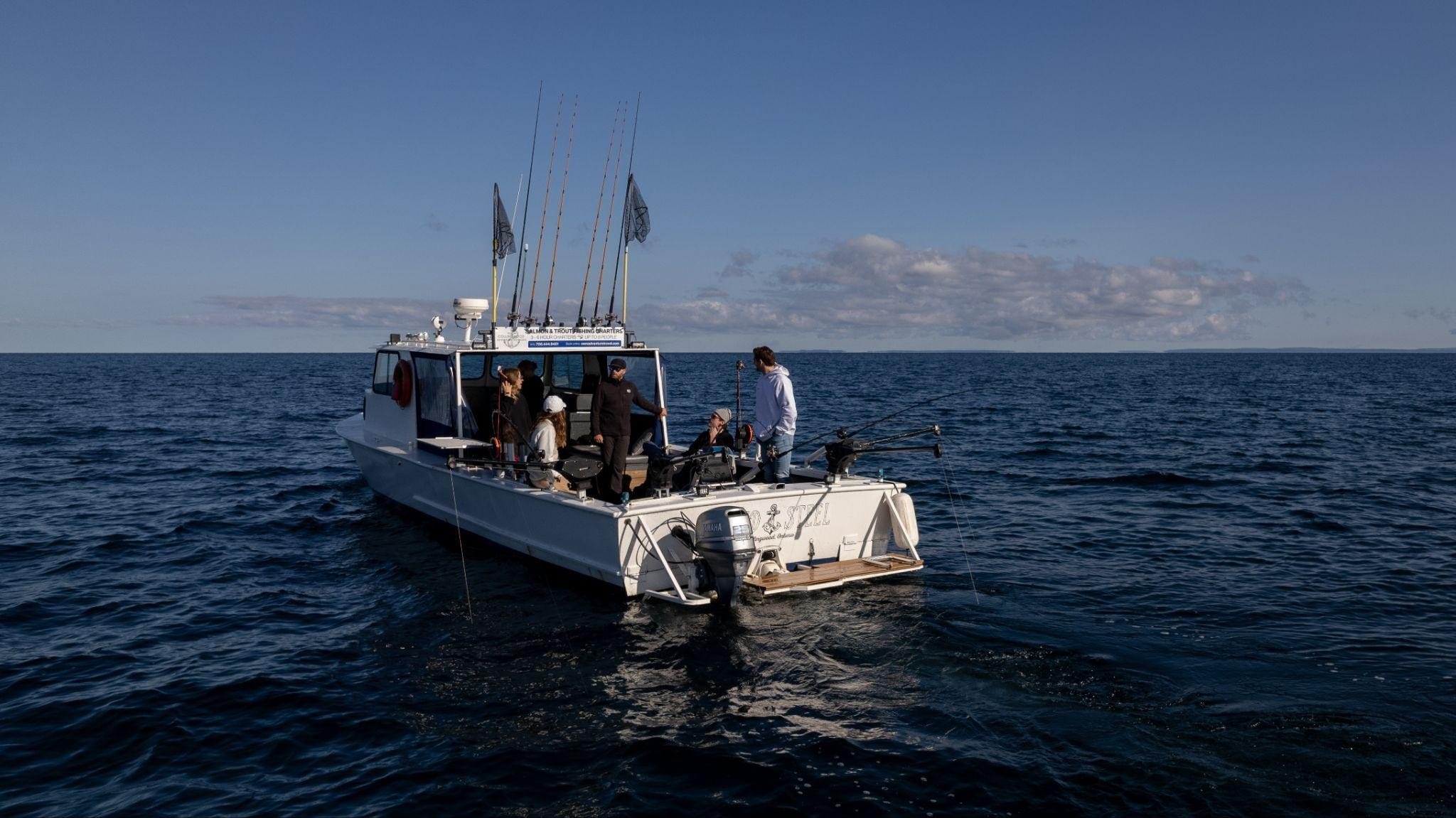 People fishing aboard the “Solid Steel” vessel in the open Georgian Bay